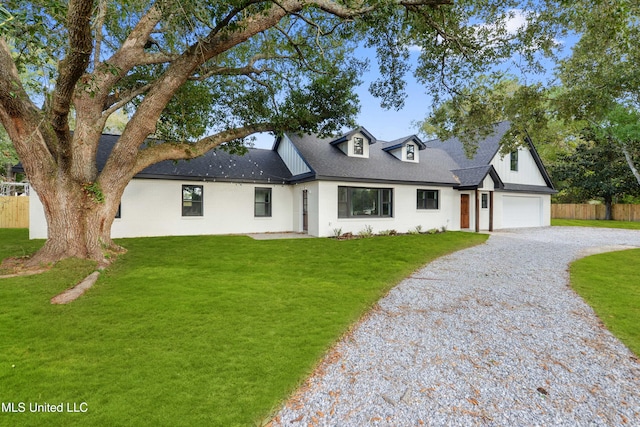 view of front of property featuring a garage and a front yard