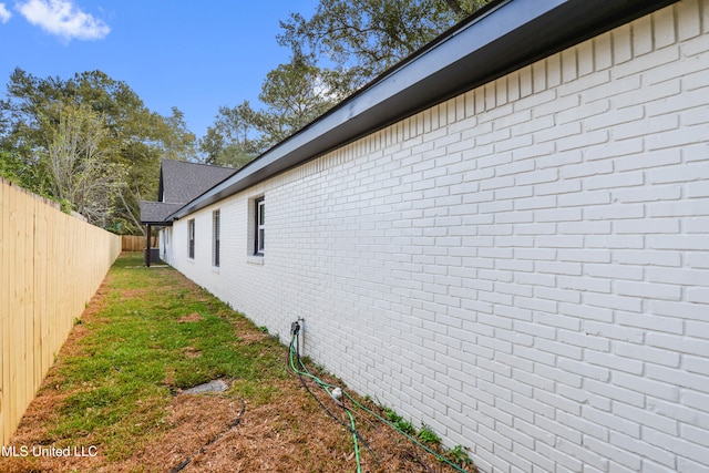 view of side of property featuring a yard