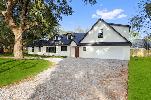 modern farmhouse style home with a garage and a front yard