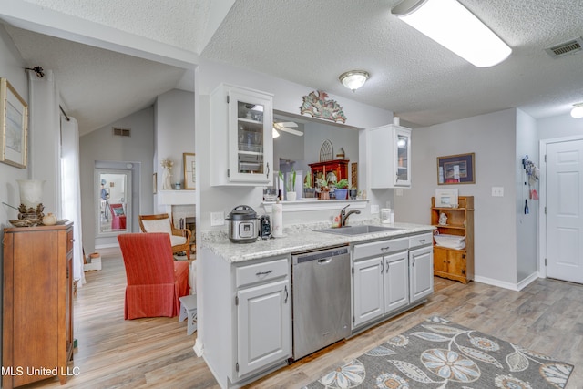 kitchen featuring white cabinetry, dishwasher, visible vents, and a sink