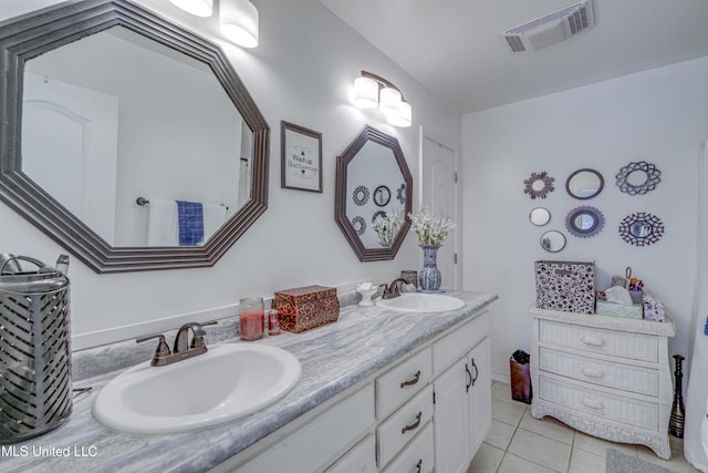 full bathroom with double vanity, visible vents, a sink, and tile patterned floors