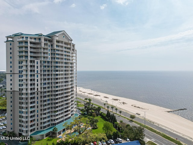 aerial view with a water view and a beach view