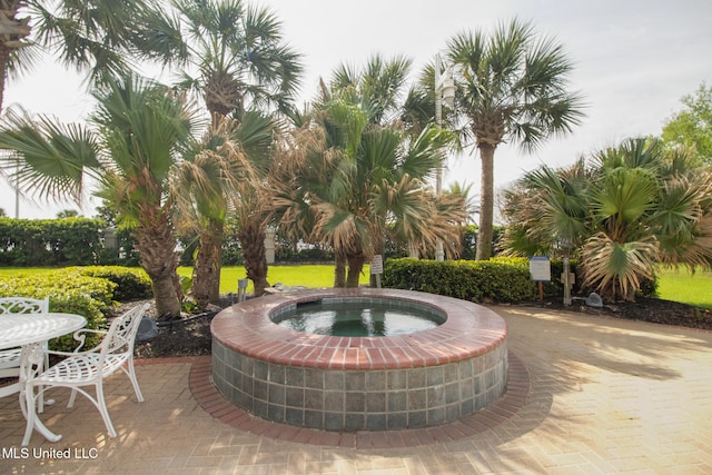 view of patio featuring an in ground hot tub