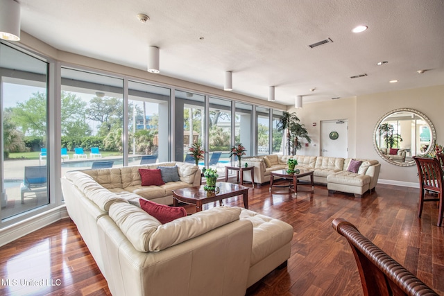 living room with hardwood / wood-style floors and a textured ceiling