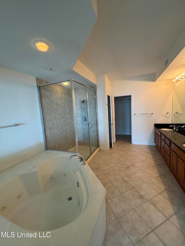 bathroom featuring vanity, independent shower and bath, and tile patterned floors