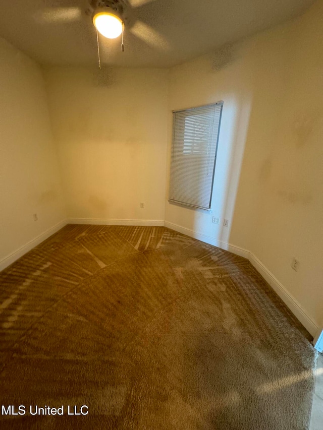 empty room featuring carpet floors and ceiling fan