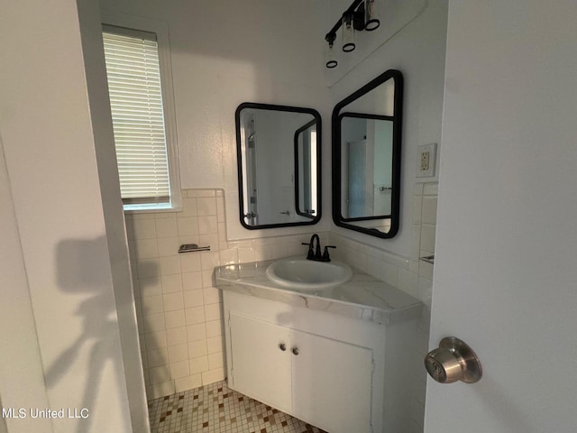 bathroom featuring tile walls and vanity