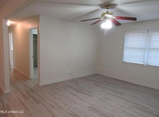 unfurnished room featuring ceiling fan and light hardwood / wood-style flooring