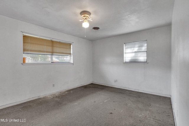 unfurnished room with light colored carpet and a wealth of natural light