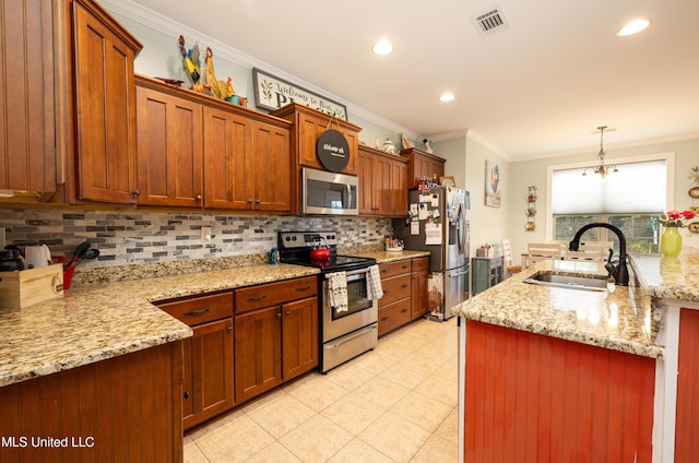 1668 Farindale Cv, Nesbit, MS 38651 - kitchen with stainless steel appliances, decorative backsplash, ornamental molding, light tile patterned floors, and decorative light fixtures