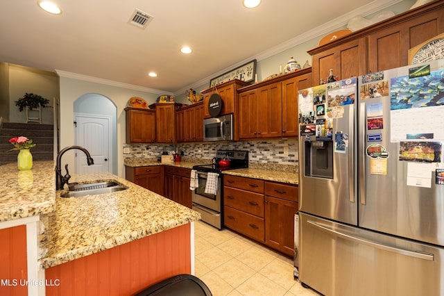 1668 Farindale Cv, Nesbit, MS 38651 - kitchen with stainless steel appliances, ornamental molding, backsplash, light tile patterned floors, and recessed lighting