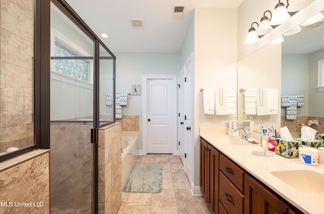 1668 Farindale Cv, Nesbit, MS 38651 - full bath featuring a garden tub, double vanity, a shower stall, and tile patterned flooring