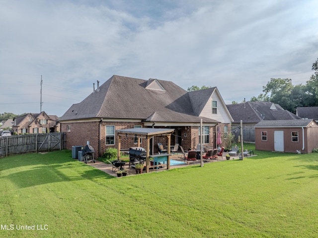 1668 Farindale Cv, Nesbit, MS 38651 - rear view of property with brick siding, a fenced backyard, a patio, a storage shed, and a shingled roof