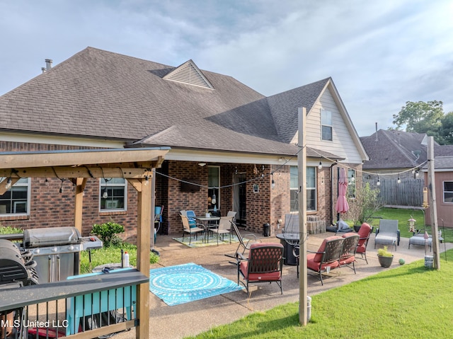 1668 Farindale Cv, Nesbit, MS 38651 - back of house with brick siding, roof with shingles, a patio area, and outdoor dining area