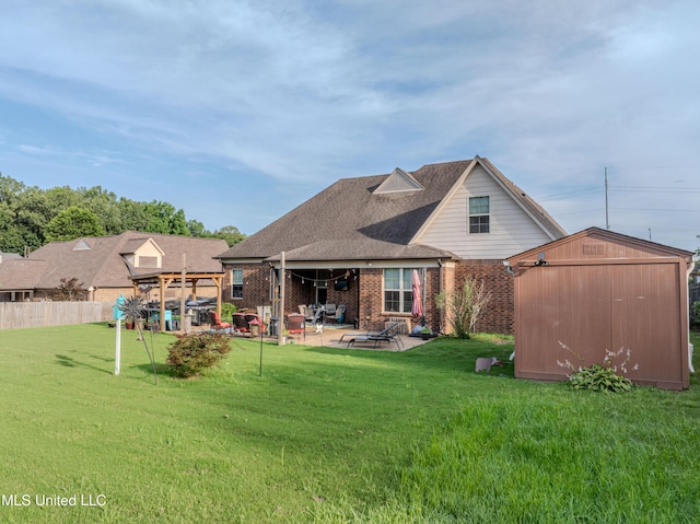 1668 Farindale Cv, Nesbit, MS 38651 - rear view of property with a shed, a patio, brick siding, and roof with shingles