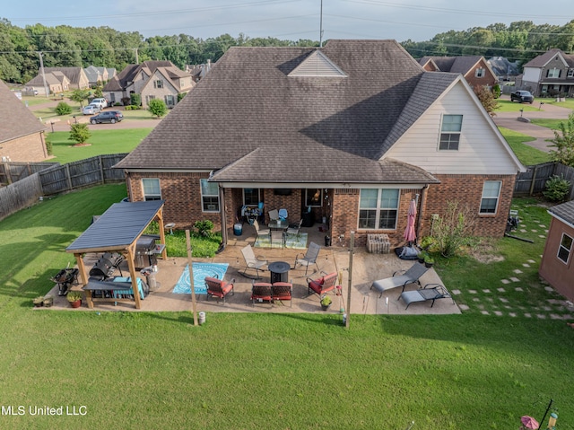 1668 Farindale Cv, Nesbit, MS 38651 - rear view of house with brick siding, a gazebo, a fire pit, a residential view, and a fenced backyard