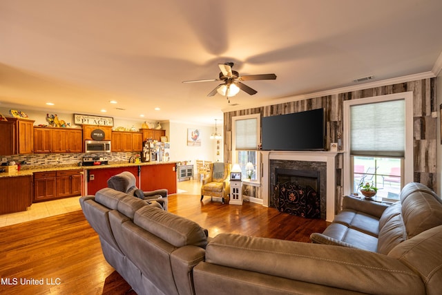 1668 Farindale Cv, Nesbit, MS 38651 - living area with ceiling fan, ornamental molding, a fireplace, and wood finished floors