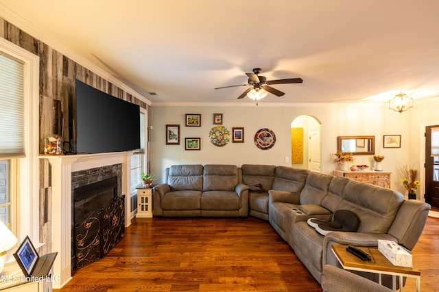 1668 Farindale Cv, Nesbit, MS 38651 - living room with arched walkways, ceiling fan, dark wood-style flooring, a tile fireplace, and ornamental molding