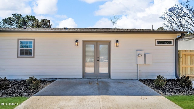 view of exterior entry featuring fence, a patio, and french doors