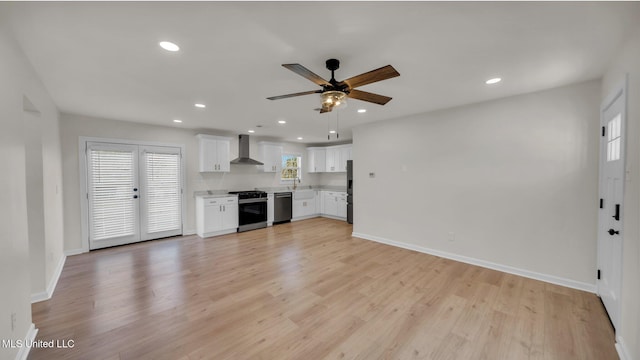 unfurnished living room with light wood-type flooring, baseboards, and recessed lighting