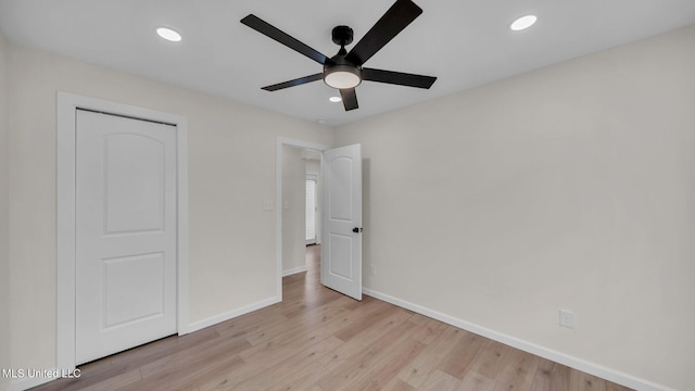 unfurnished bedroom with recessed lighting, light wood-type flooring, a ceiling fan, and baseboards