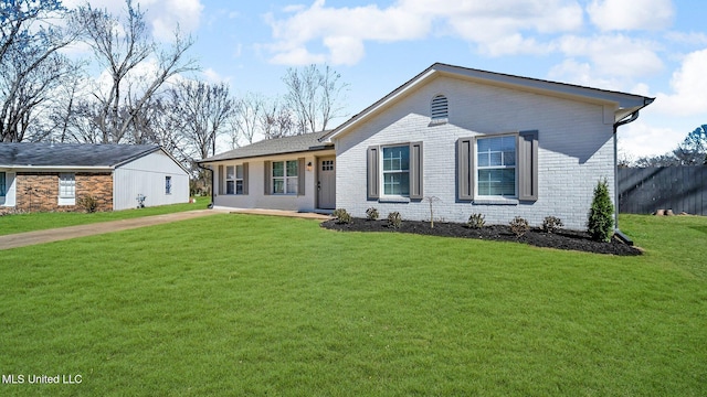 ranch-style home featuring a front yard and brick siding