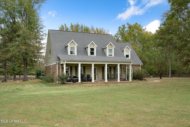 cape cod house with covered porch and a front yard