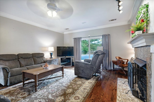 living room featuring ceiling fan, crown molding, and wood-type flooring