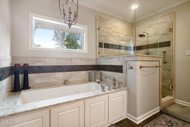 bathroom with hardwood / wood-style floors, ornamental molding, and separate shower and tub