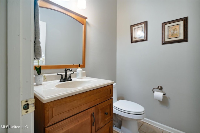 bathroom featuring tile patterned floors, vanity, and toilet