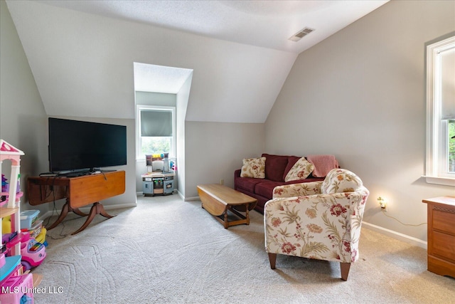 living room with light colored carpet and lofted ceiling