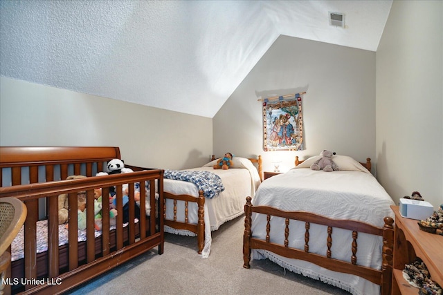 bedroom featuring vaulted ceiling, light carpet, and a textured ceiling