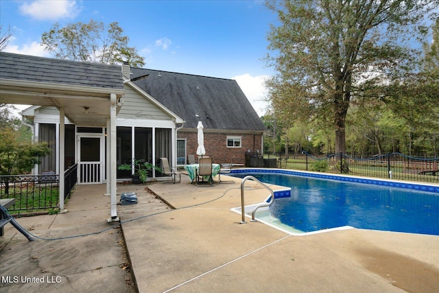 view of pool featuring a patio and a sunroom