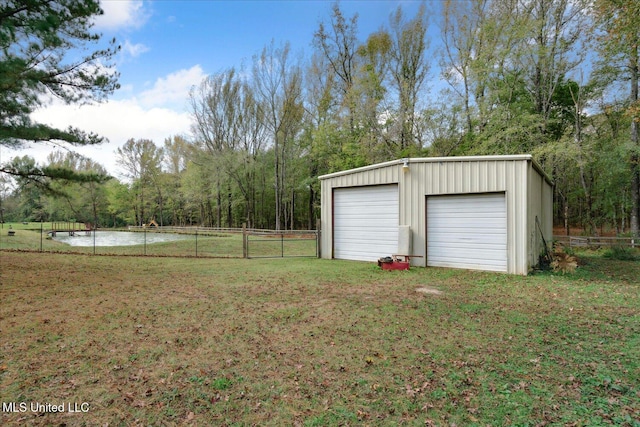 garage with a water view and a lawn