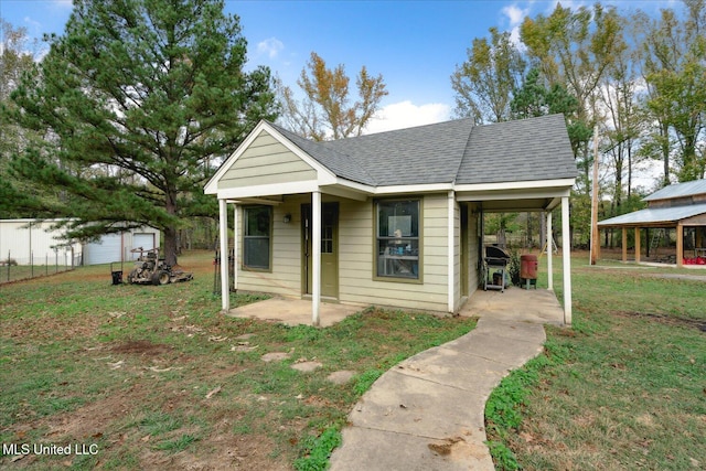 bungalow-style house with a front yard and a carport