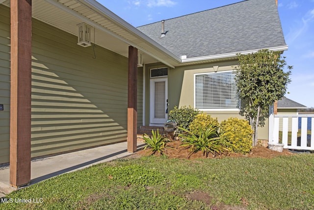 property entrance with a lawn