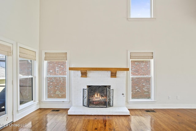 unfurnished living room with a fireplace and hardwood / wood-style flooring