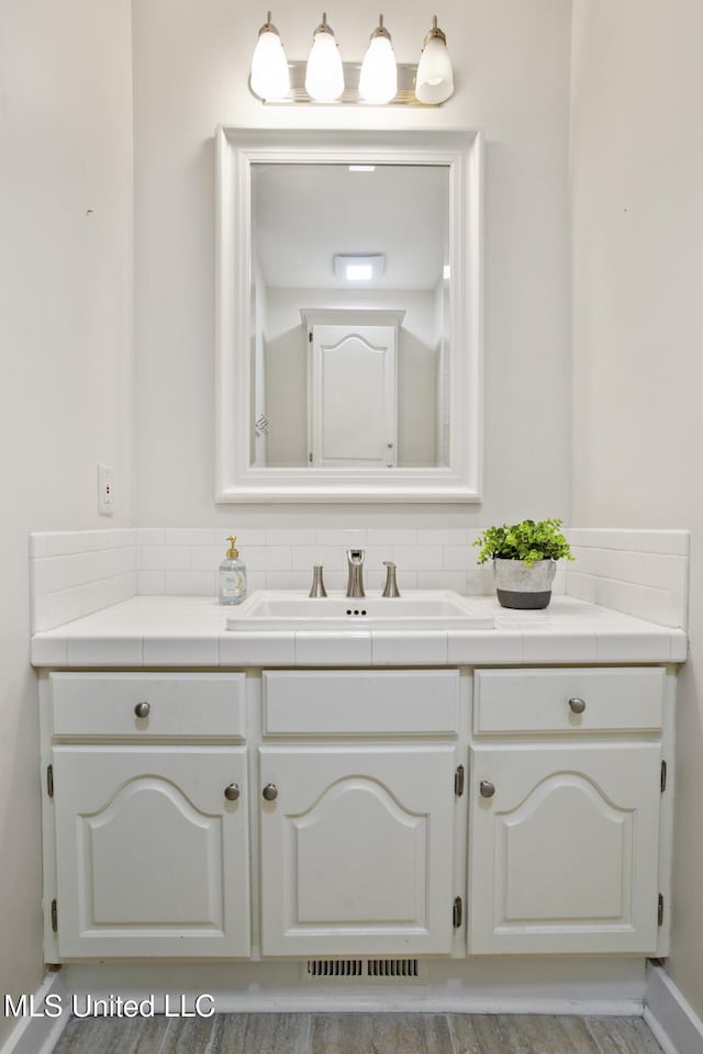 bathroom with hardwood / wood-style floors and vanity