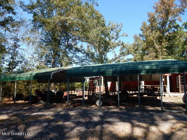 view of parking / parking lot with a carport