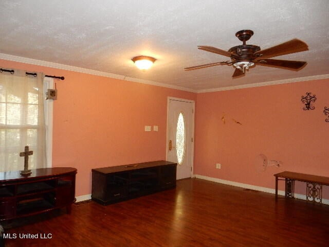 entryway featuring crown molding, a textured ceiling, ceiling fan, and dark hardwood / wood-style flooring