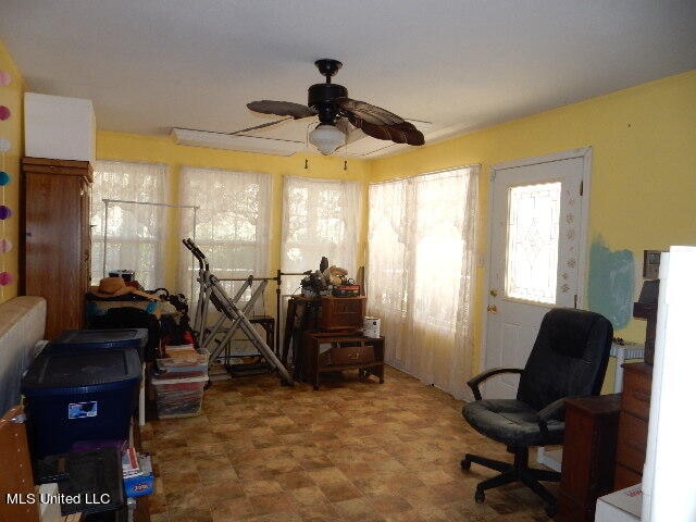 interior space featuring ceiling fan