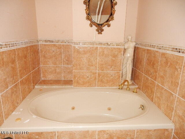 bathroom featuring tiled bath