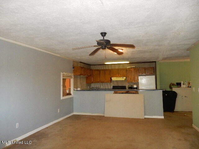 kitchen with light carpet, white fridge, a textured ceiling, and ceiling fan