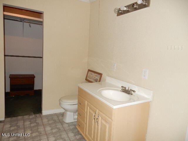 bathroom featuring toilet and vanity