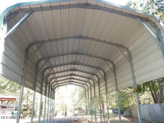 view of vehicle parking featuring a carport