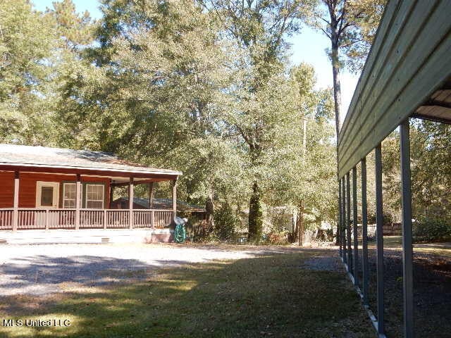 view of yard with covered porch