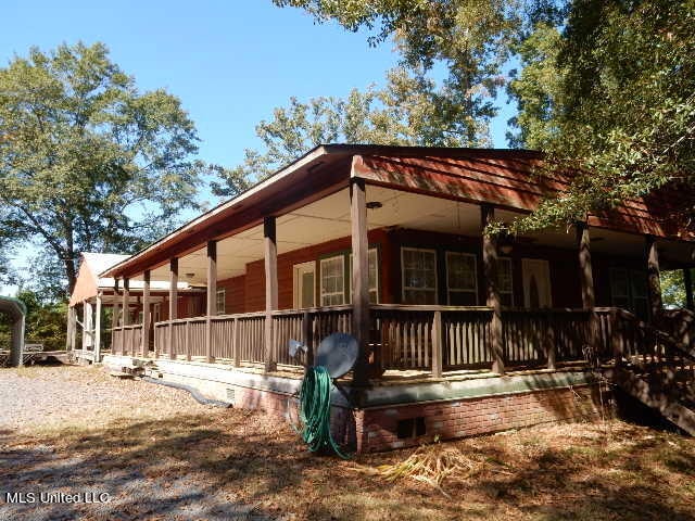 view of side of home featuring a porch