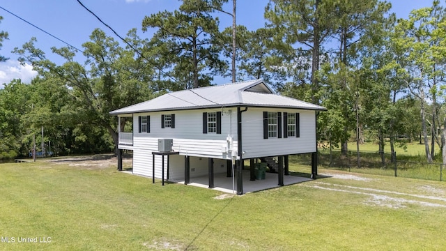 5061 1st Ave, Bay Saint Louis, MS 39520 - view of front of house featuring a carport, metal roof, and view of wooded area