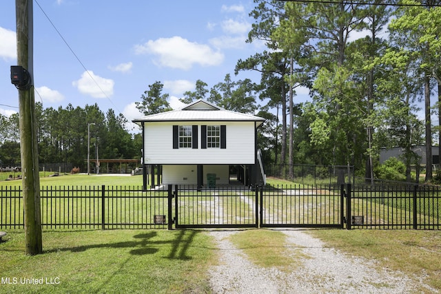 5061 1st Ave, Bay Saint Louis, MS 39520 - view of front of property with a gate, driveway, and metal roof