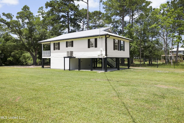 5061 1st Ave, Bay Saint Louis, MS 39520 - back of house featuring stairway, a carport, and a yard